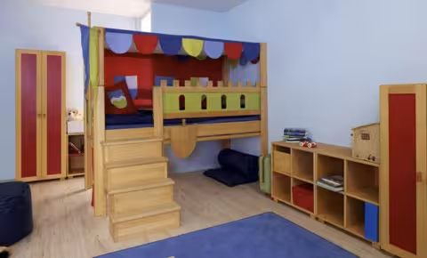 kids bunk bed with stairs having decorative walls and wooden shelf